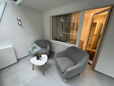 a living room with two chairs and a table at Peaceful Apartment Lazdynai in Vilnius