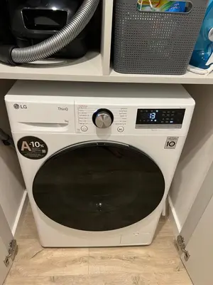 a white microwave oven sitting on top of a shelf at Peaceful Apartment Lazdynai in Vilnius