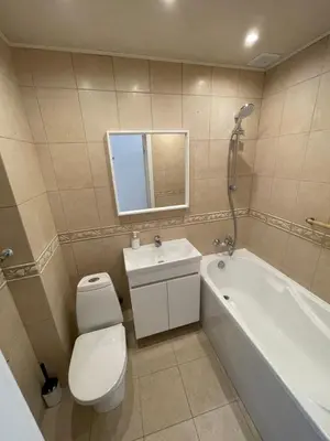 a bathroom with a toilet and a tub and a sink at Karoliniškių apartamentai in Vilnius