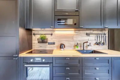 a kitchen with stainless steel cabinets and a sink at cohost I Newly Built Apartments by Historical Bastion Wall, Self check in in Vilnius