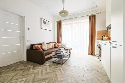 a living room with a couch and a table at cohost I Newly Built Apartments by Historical Bastion Wall, Self check in in Vilnius