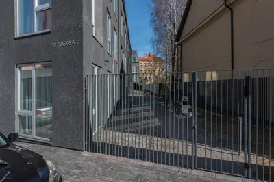 a wrought iron fence in front of a building at cohost I Newly Built Apartments by Historical Bastion Wall, Self check in in Vilnius