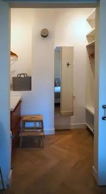 a hallway with a table and a room with a bed at Daina Apartments Self check-in in Vilnius