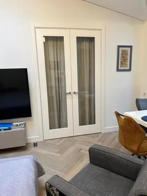 a living room with a tv and a couch and a tvictericter at Daina Apartments Self check-in in Vilnius