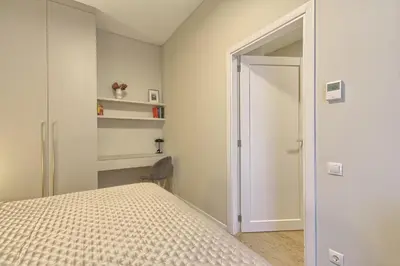 a bedroom with a bed and an open door at Ruby Rest in Druskininkai