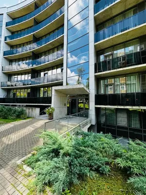 an office building with a garden in front of it at Ruby Rest in Druskininkai