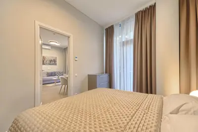 a hotel room with a bed and a mirror at Ruby Rest in Druskininkai