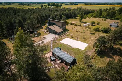 an aerial view of a farm with a barn at Paežerės istorijos near Druskininkai in Veršiai