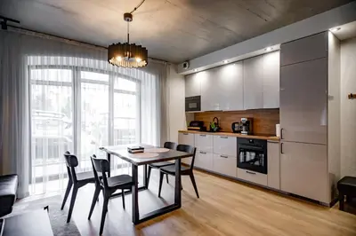 a kitchen and dining room with a table and chairs at Hales Old Town Urban Apartments in Vilnius