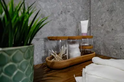 a table with a bottle of soap and a plant at Hales Old Town Urban Apartments in Vilnius