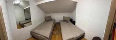 a small room with two beds and a mirror at Svečių Namai Darželis in Šiauliai