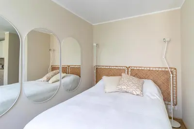 a bedroom with three mirrors above a bed at Harmony Hill Apartments in Druskininkai