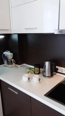 a kitchen counter with two cups and a tea kettle at Centro apartamentai - Vingio apartamentai in Vilnius