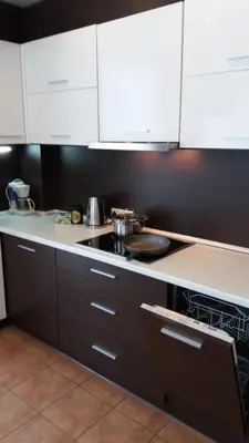 a kitchen with white cabinets and a stove top oven at Centro apartamentai - Vingio apartamentai in Vilnius