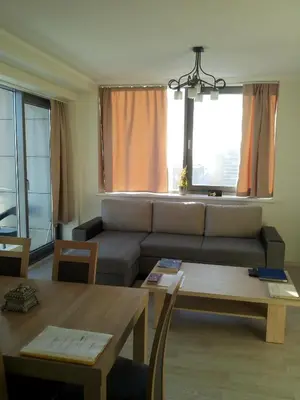 a living room with a couch and a table at Centro apartamentai - Vingio apartamentai in Vilnius