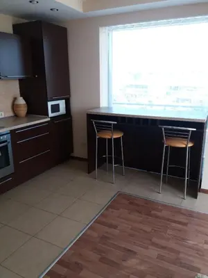 a kitchen with a counter and stools in a room at Centro apartamentai - Vingio apartamentai in Vilnius