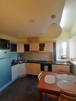 a kitchen with a table and a dining room at Jauki erdvĖ in Vilnius