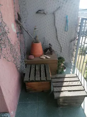a balcony with a table and a lamp on it at Jauki erdvĖ in Vilnius