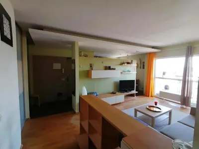 a living room with a couch and a table at Jauki erdvĖ in Vilnius