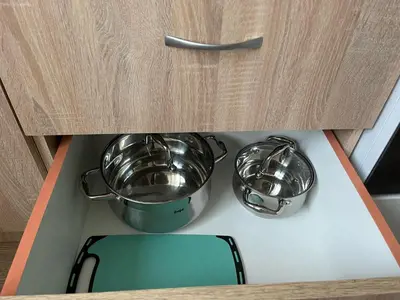 two pots and pans sitting on top of a stove at Jaukus butas arti Šiaulių miesto in Šiauliai