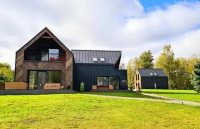 a modern house with a black roof at Sofijos Slėnis in Pakniškiai