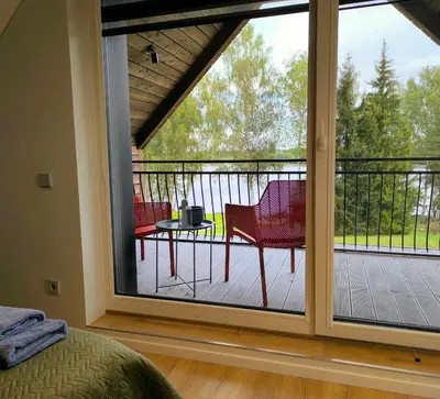 a bedroom with a large sliding glass door at Sofijos Slėnis in Pakniškiai