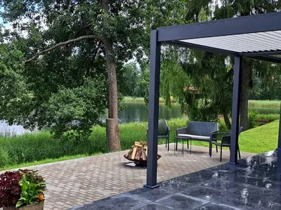 a gazebo with two chairs and a fire pit at Sofijos Slėnis in Pakniškiai