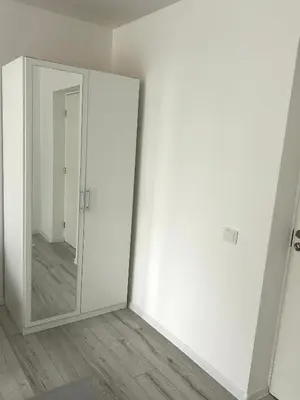an empty room with a mirror and a white wall at Vivist apartments in Druskininkai