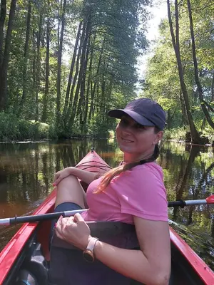 a woman in a kayak on a river at Merkioaidas in Sližiūnai