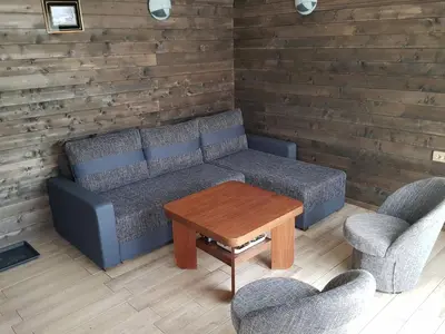 a living room with a couch and two chairs and a table at Merkioaidas in Sližiūnai