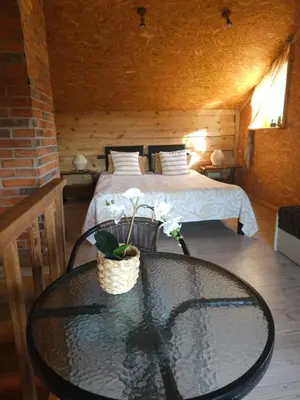 a room with a bed and a glass table with a bed at Namelis Birštono mieste in Birštonas