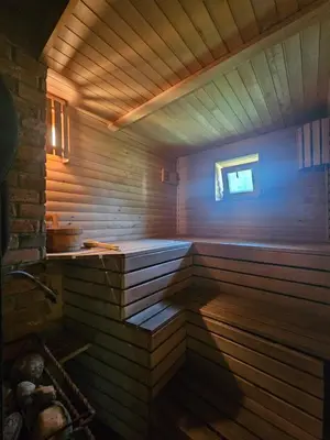 a sauna with wooden walls and a wooden floor at Namelis Birštono mieste in Birštonas