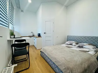 a bedroom with a bed and a desk and a chair at UAB DU PROCENTAI nt in Šiauliai