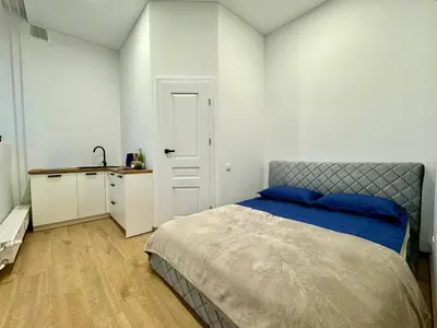 a bedroom with a bed and a desk in it at UAB DU PROCENTAI nt in Šiauliai