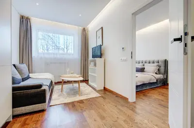 a living room with a bed and a couch at Modern Apartment near Old Town & River in City Center in Vilnius