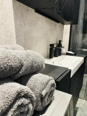 a kitchen with a sink and towels on a counter at Modern Apartment near Old Town & River in City Center in Vilnius