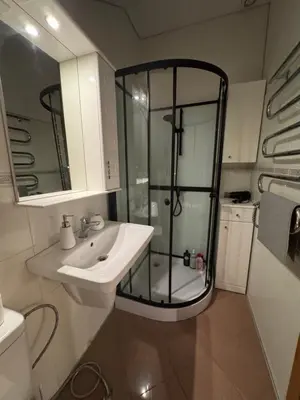 a bathroom with a glass shower and a sink at Old Town loft in Vilnius
