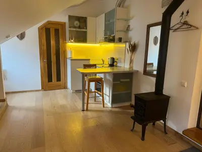 a kitchen with a table and a stove in a room at Old Town loft in Vilnius