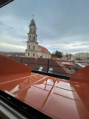 a view from the roof of a building with a clock tower at Old Town loft in Vilnius