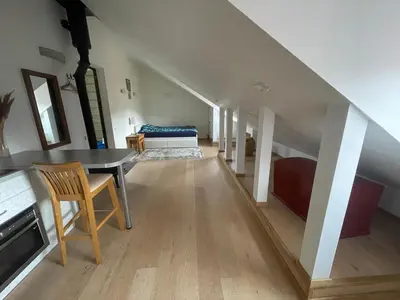 a living room with a table and a couch at Old Town loft in Vilnius