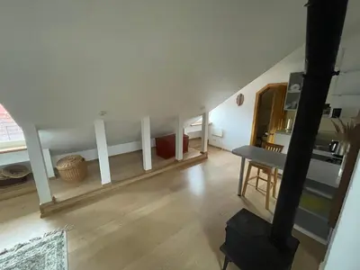 a room with a staircase with a table in it at Old Town loft in Vilnius