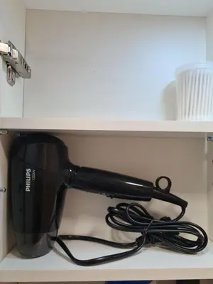 a black appliance sitting on top of a shelf at Butterfly apartment in Šiauliai