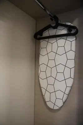a light hanging from a wall in a room at Butterfly apartment in Šiauliai