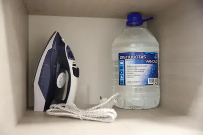 a bottle of water and a telephone and a bottle of water at Butterfly apartment in Šiauliai