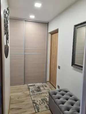 a living room with a sliding glass door at Butterfly apartment in Šiauliai