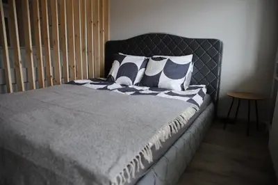 a bed with blue and white pillows on it at Butterfly apartment in Šiauliai