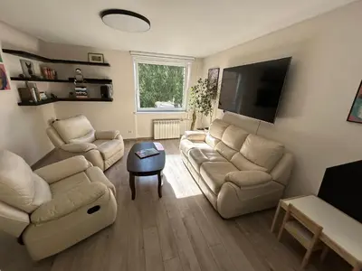 a living room with two couches and a flat screen tv at Algirdo Apartments, Self Check-in, Free Private Parking in Vilnius