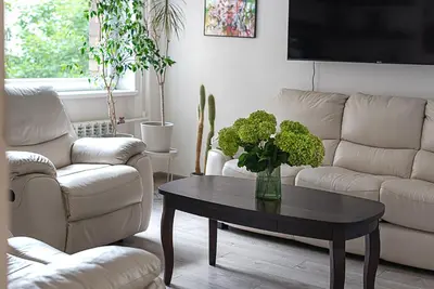 a living room with two couches and a table with a vase at Algirdo Apartments, Self Check-in, Free Private Parking in Vilnius