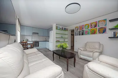 a living room with two white couches and a table at Algirdo Apartments, Self Check-in, Free Private Parking in Vilnius