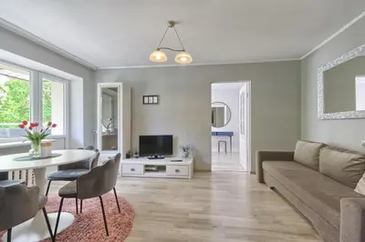 a living room with a couch and a table at Apartamentai Vilniaus alėjoje in Druskininkai